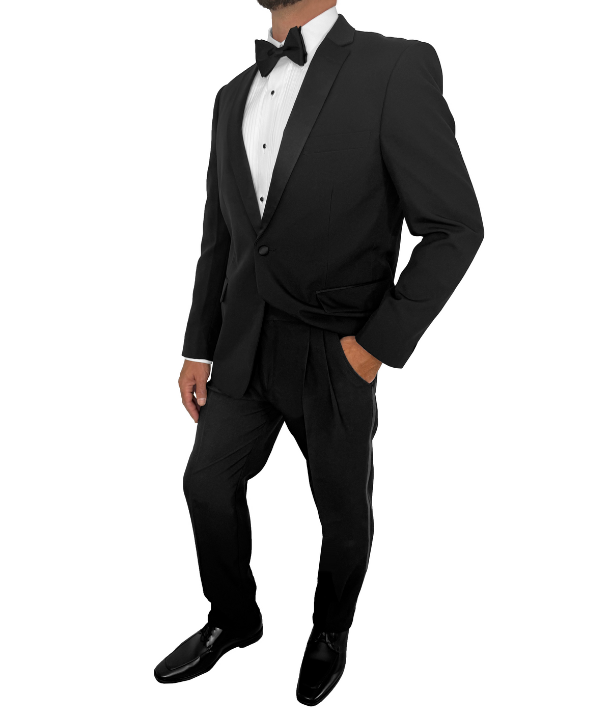 A man wearing a classic black tuxedo with satin lapels, a white dress shirt, a black bow tie, black pleated pants, and black dress shoes, shown against a plain white background.