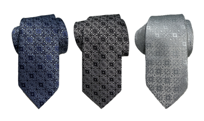 Three rolled floral medallion-patterned ties in blue, black, and gray on a white background