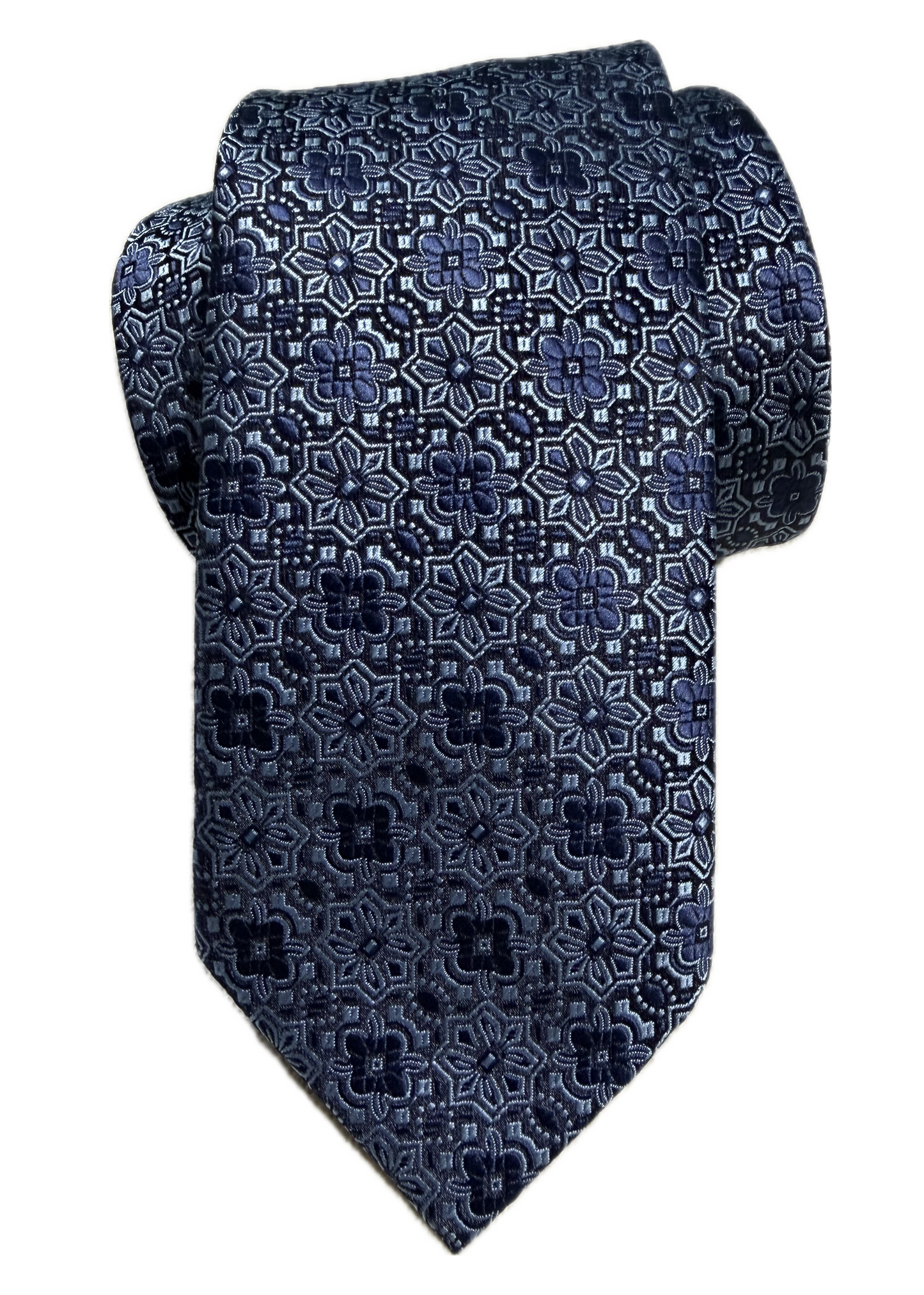 A rolled navy blue floral medallion-patterned tie on a white background
