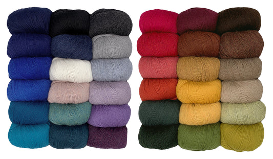 36 yarn skeins in two rows in various colors on a white background