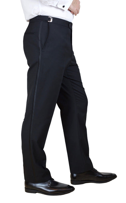 Person wearing black dress pants and black shoes on a white background